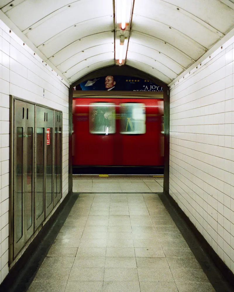 A red train is traveling through a tunnel.
