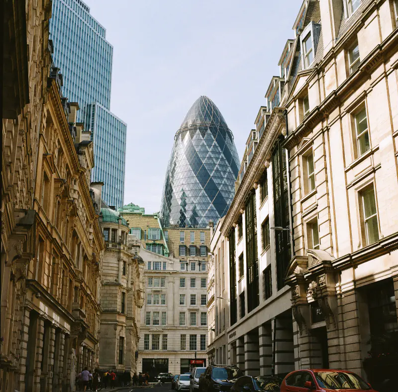 A city street with a large building in the background.