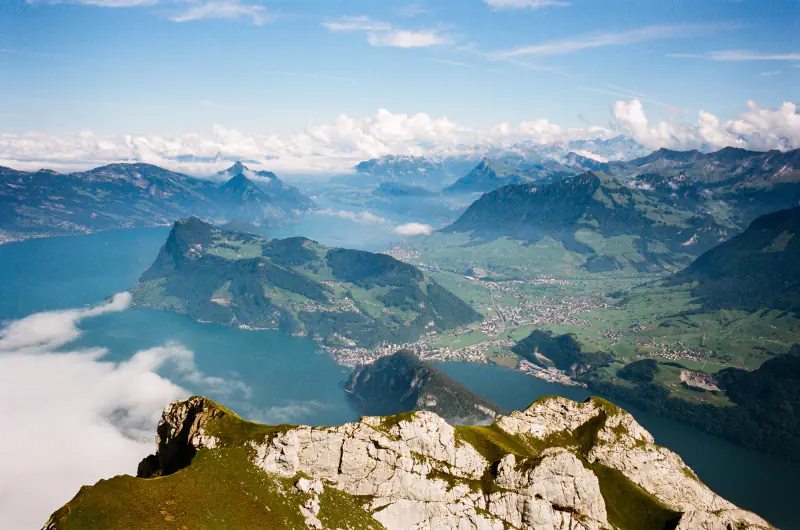 A mountain range with a valley and a lake.