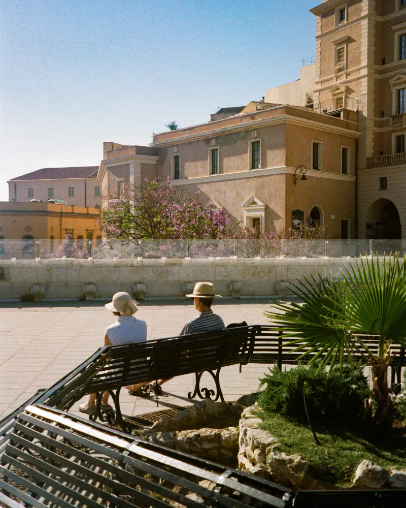 Photo of two people on a bench
