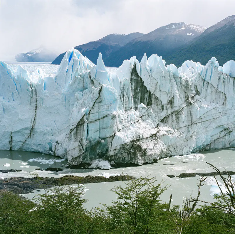 A large iceberg is floating in the water.