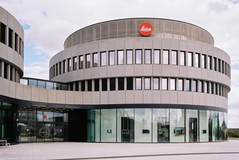 A large building with a red logo on the side.
