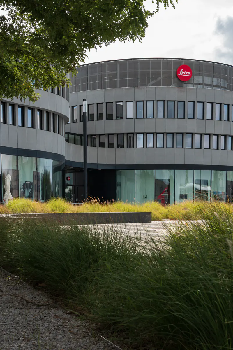 A large building with a red logo on the side.